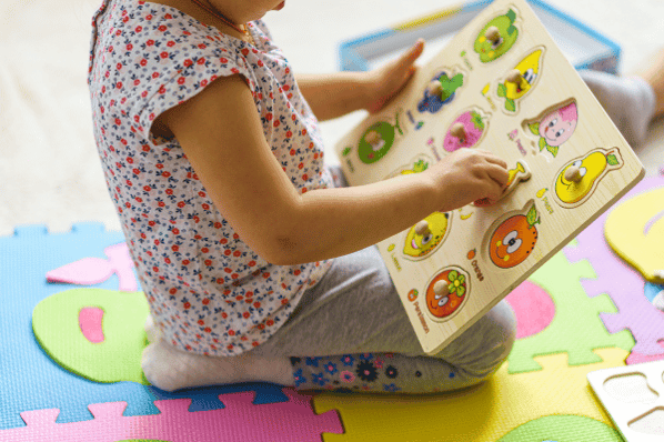 Child playing with educational toy puzzle