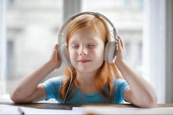 Young girl wearing headphones.