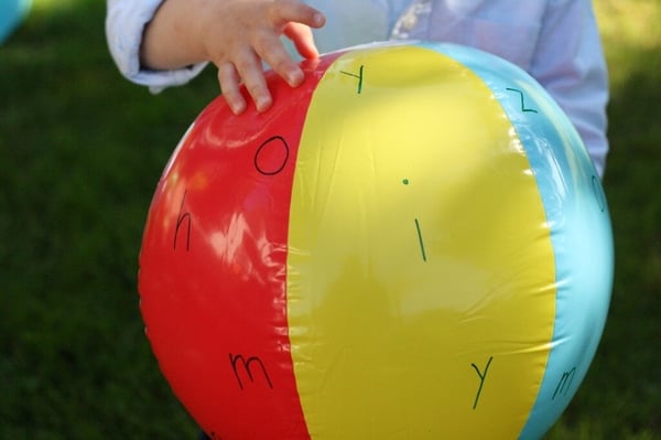 a beach ball with alphabet letters written in permanent marker