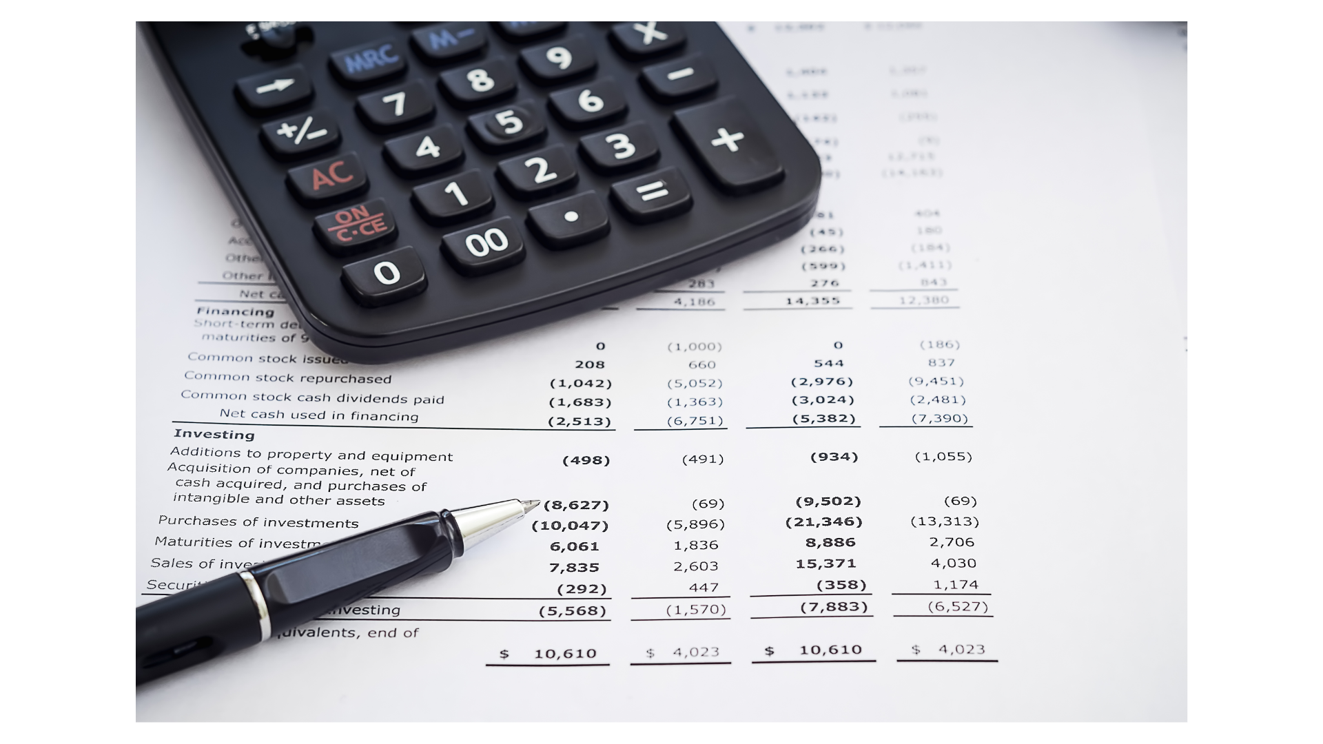 photo of printed income statement and a pen