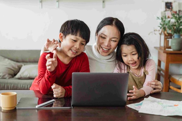 Mom with two children at laptop