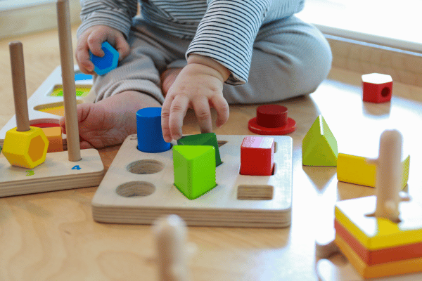 baby playing with wooden blocks