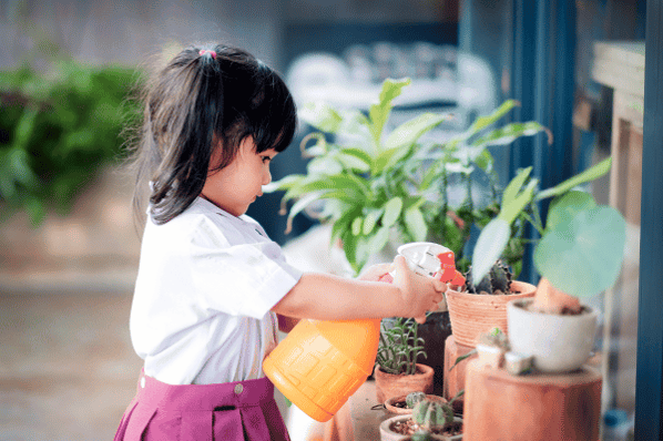 Young girl enjoying gardening activities.