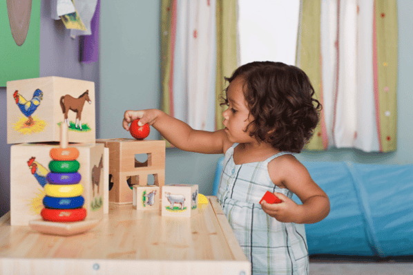 Young girl playing with toys at daycare.