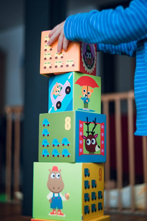 child stacking blocks