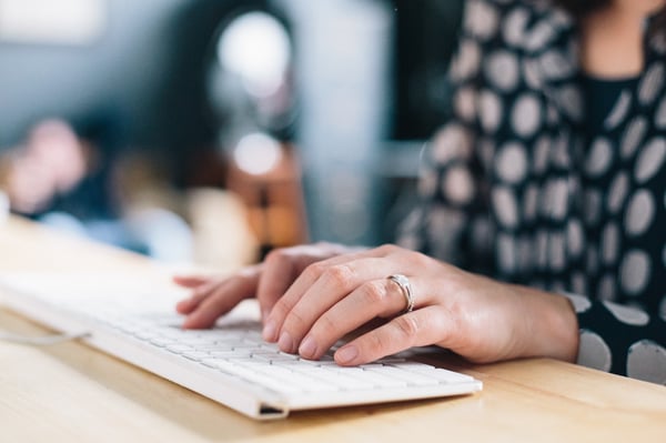 woman typing on white keyboard