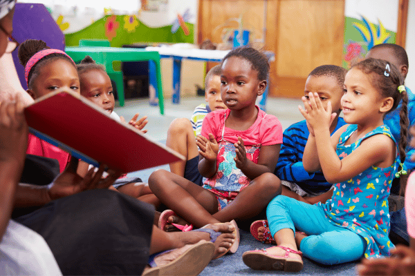 Preschool children sitting on the floor during circle story time.